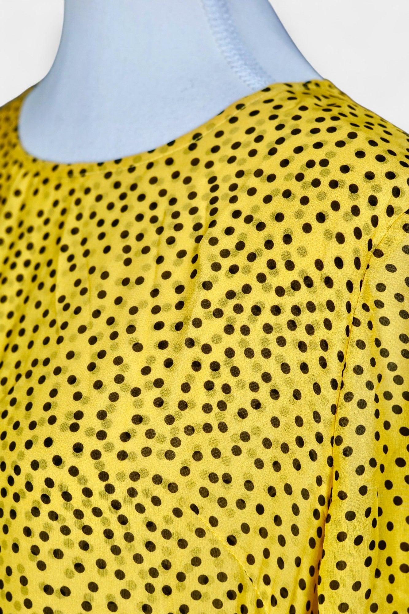 Women's yellow silk dress with black polka dots, featuring elbow-length ruffled sleeves and a gathered drop-waist hem.