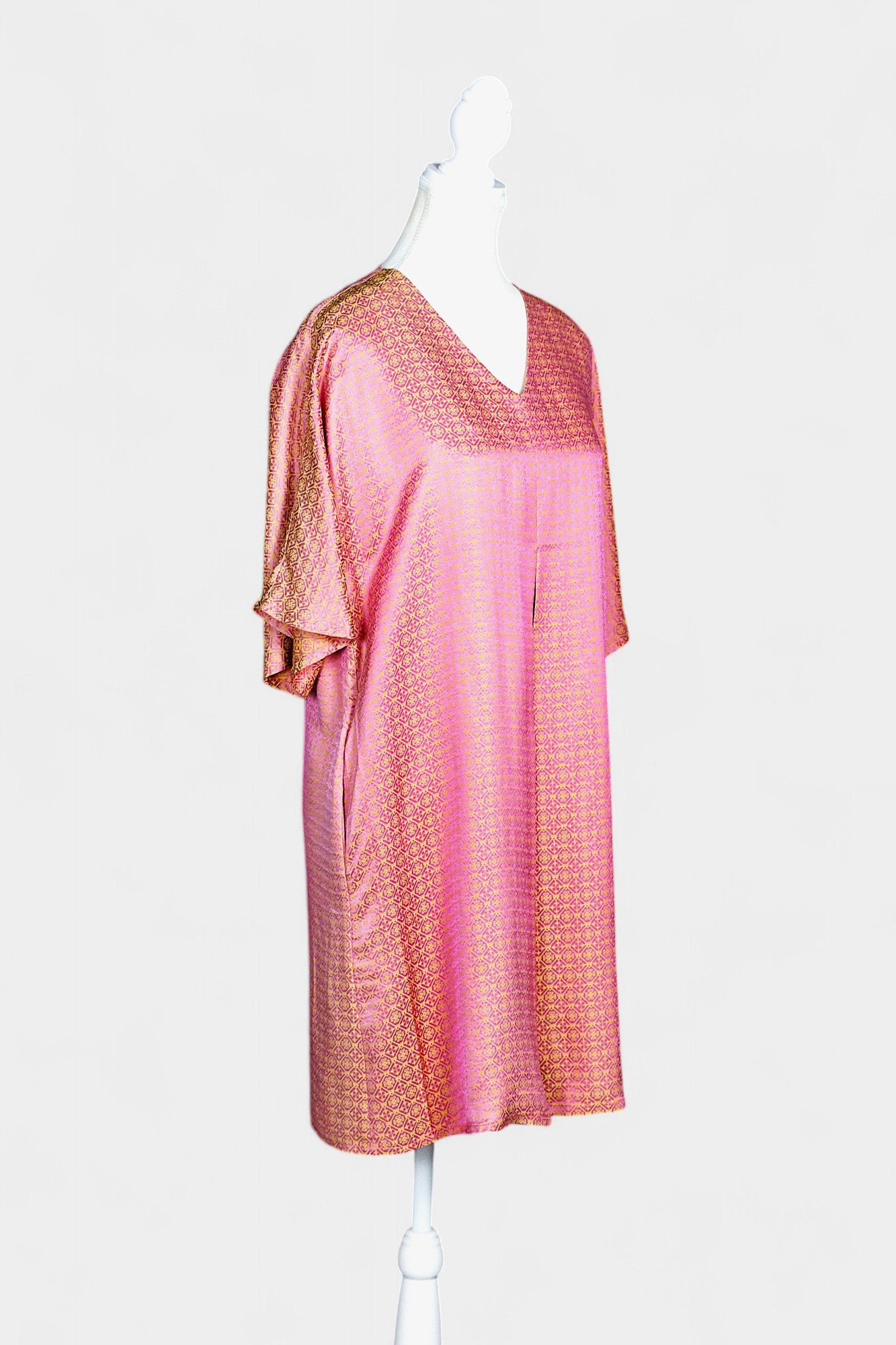Women's pink and gold Song Brocade dress with a geometric lattice pattern and V-neckline on a mannequin