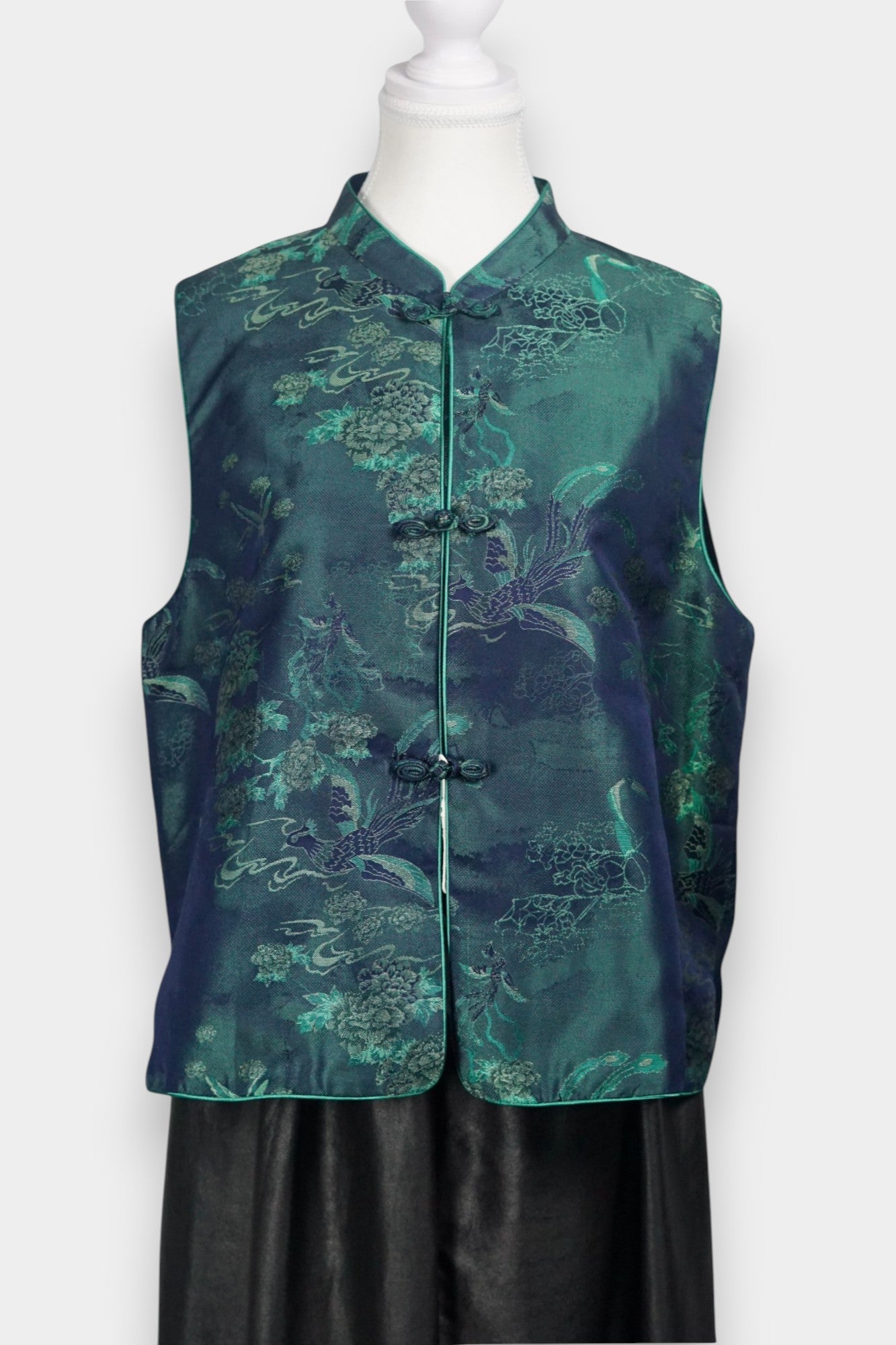 Traditional Chinese Tang suit vest featuring intricate cloud and bird patterns in teal and navy.