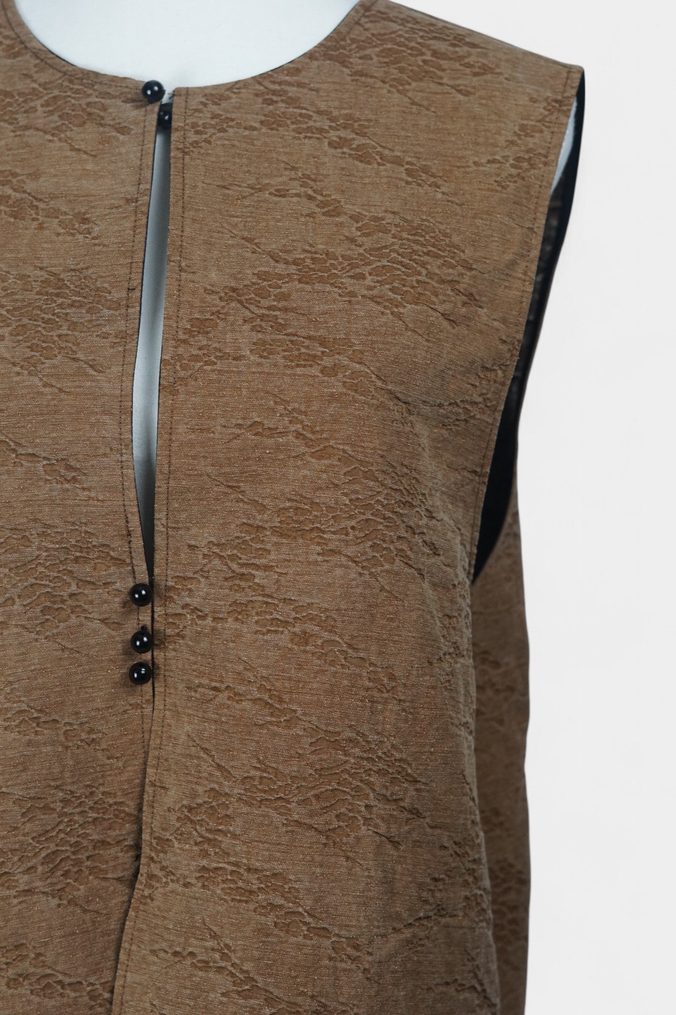 Brown Tussah silk sleeveless top featuring unique crinkled texture and black piping