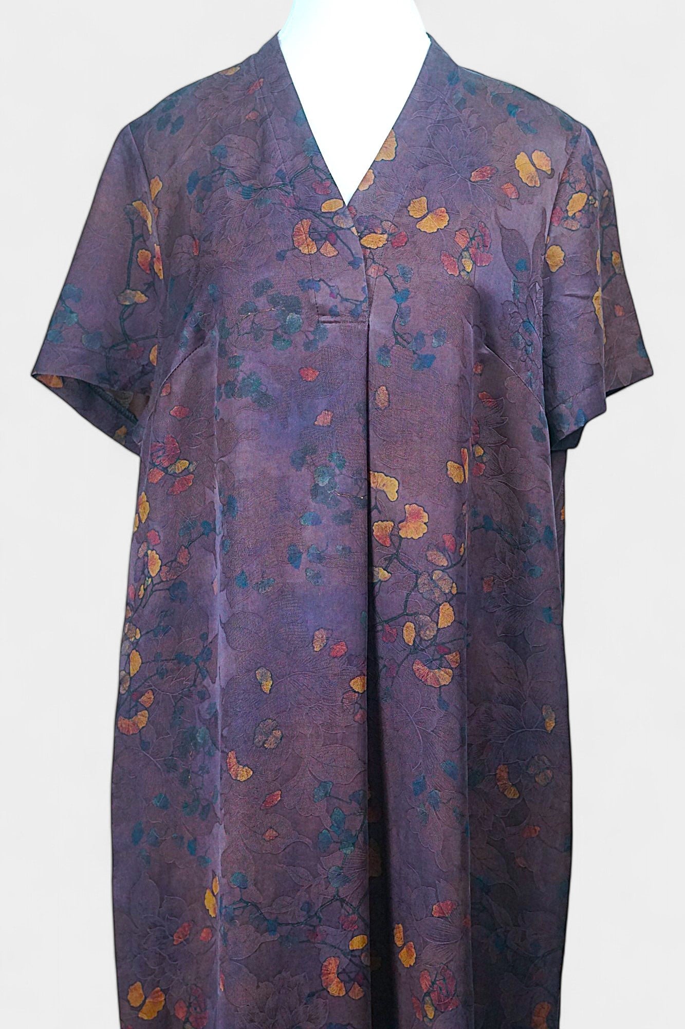 Aubergine purple Xiangyun Sha silk dress featuring a scattered autumn leaf print and V-neckline