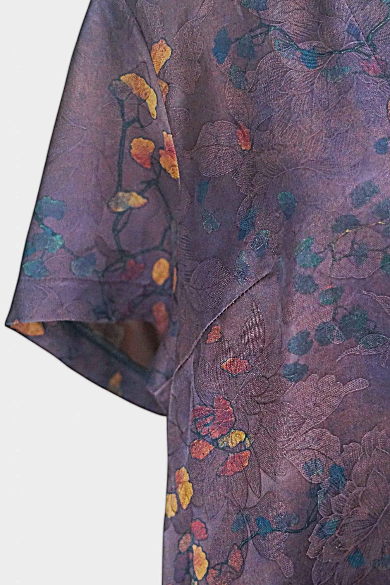 Aubergine purple Xiangyun Sha silk dress featuring a scattered autumn leaf print and V-neckline