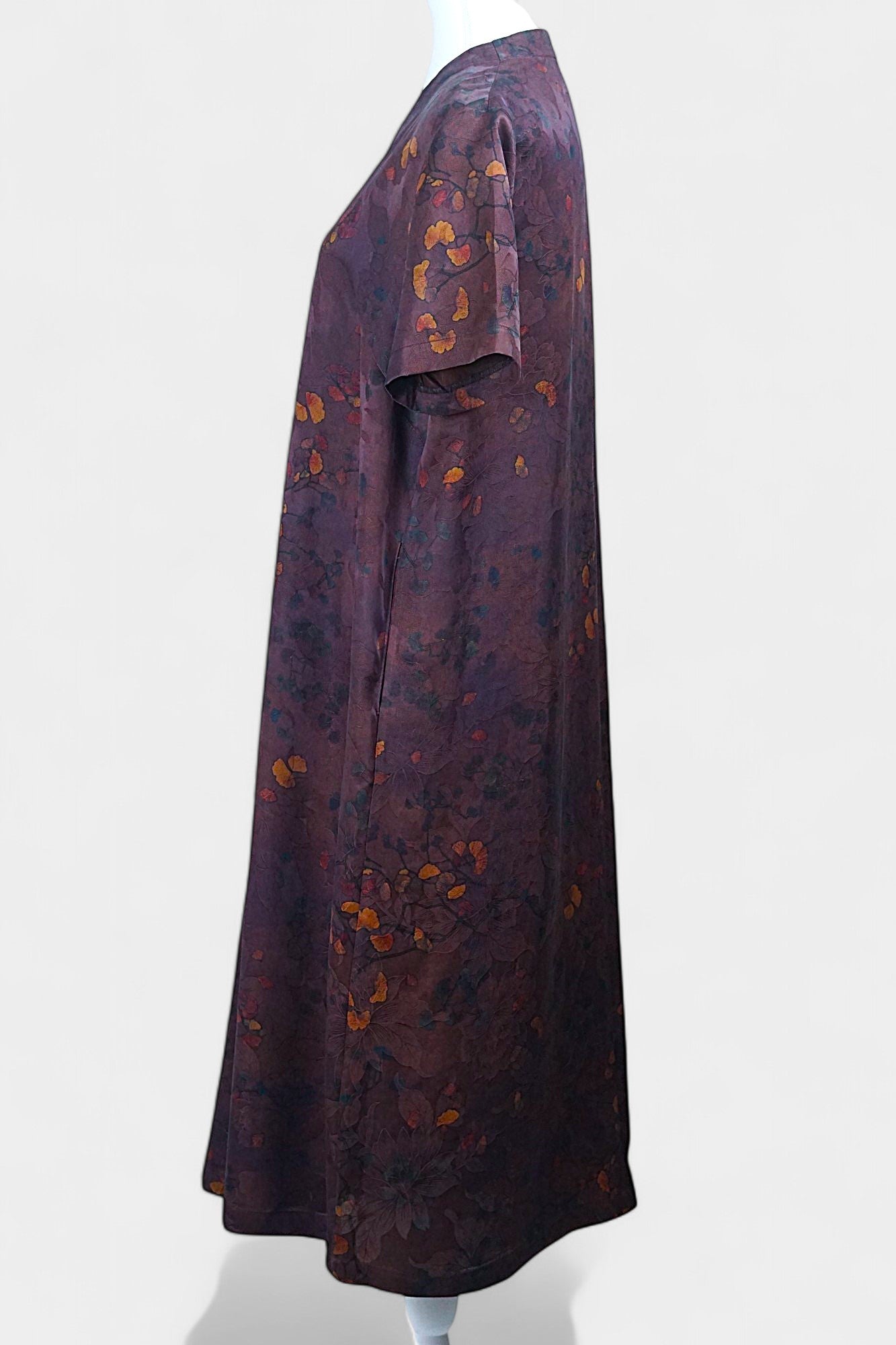 Aubergine purple Xiangyun Sha silk dress featuring a scattered autumn leaf print and V-neckline