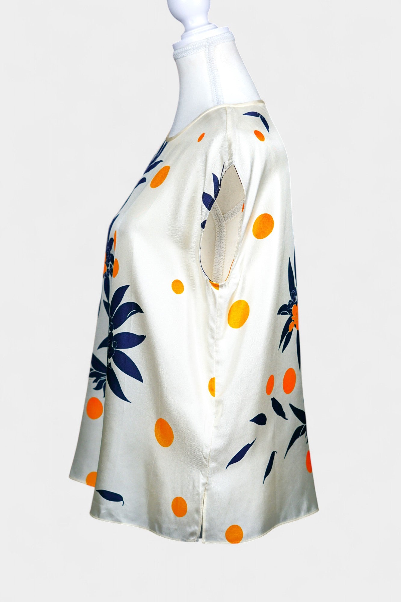 Cream silk sleeveless top featuring blue floral patterns and orange polka dots