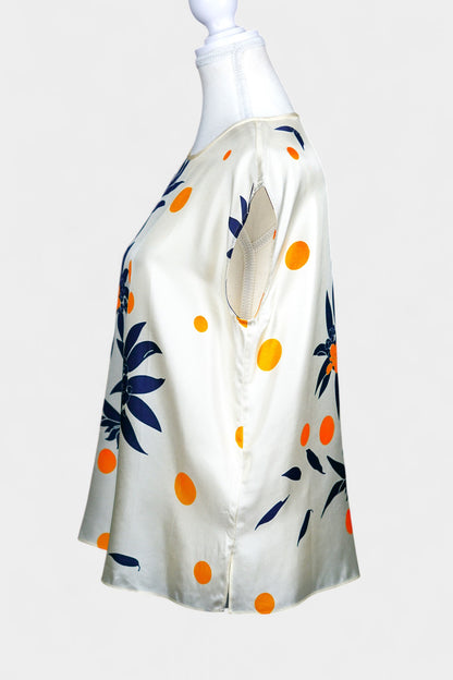 Cream silk sleeveless top featuring blue floral patterns and orange polka dots