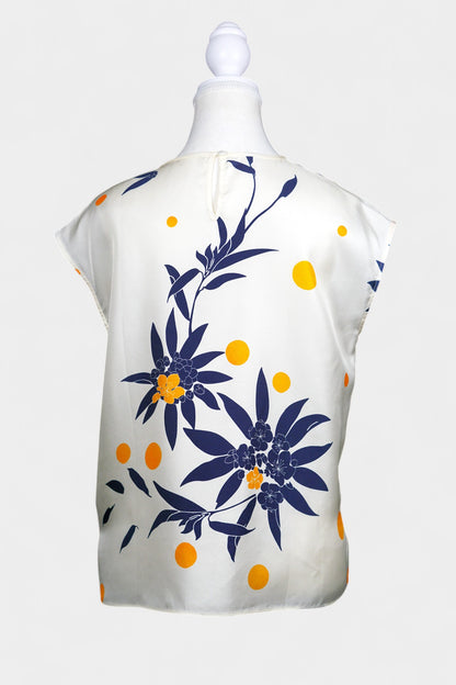 Cream silk sleeveless top featuring blue floral patterns and orange polka dots