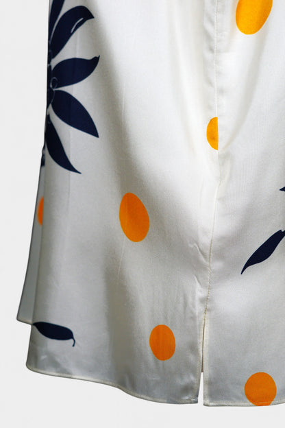 Cream silk sleeveless top featuring blue floral patterns and orange polka dots