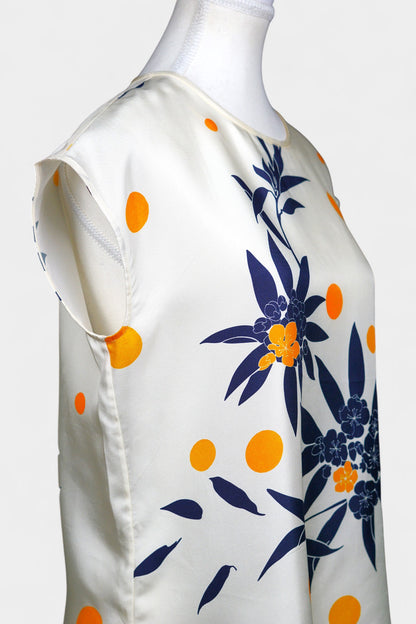 Cream silk sleeveless top featuring blue floral patterns and orange polka dots