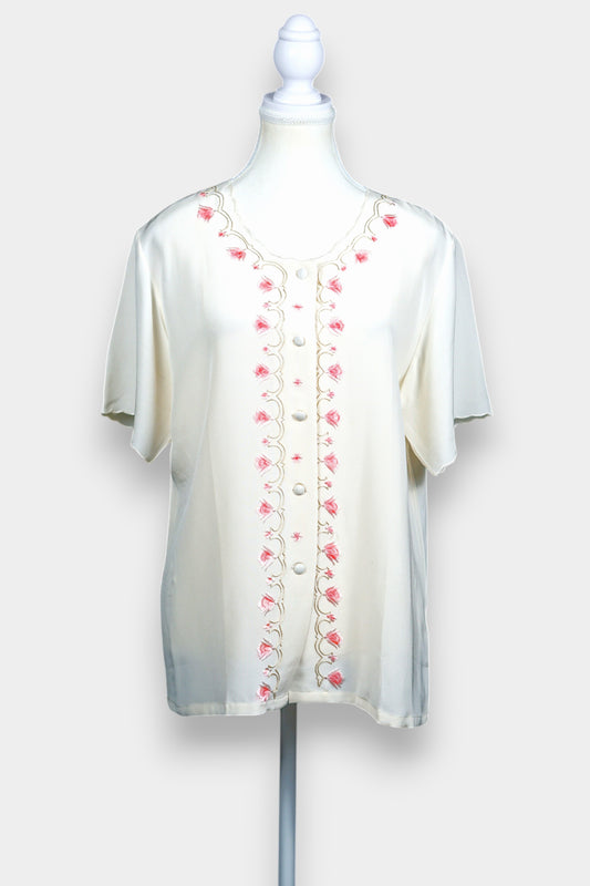 Cream silk short-sleeve blouse featuring pink floral embroidery and scalloped edges
