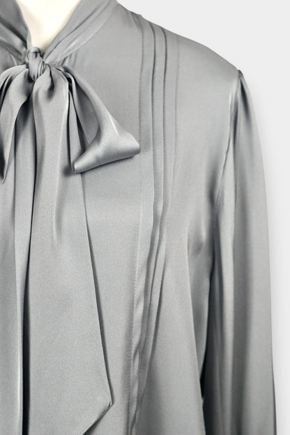 Features a versatile tie-neck design. Tie it in a structured bow for a professional look, or leave it loose for a relaxed, Parisian chic vibe