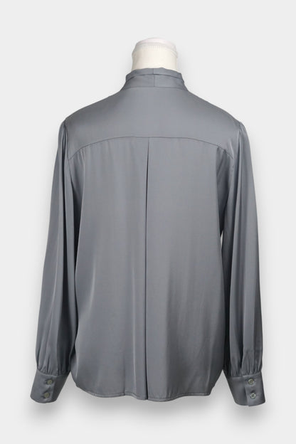 Features a versatile tie-neck design. Tie it in a structured bow for a professional look, or leave it loose for a relaxed, Parisian chic vibe