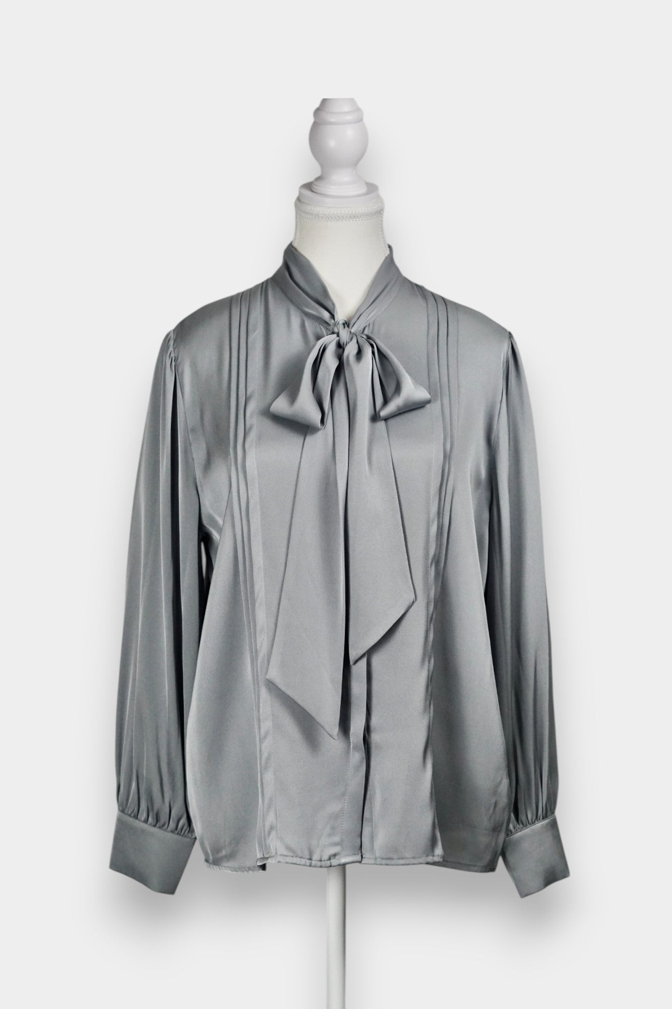 Features a versatile tie-neck design. Tie it in a structured bow for a professional look, or leave it loose for a relaxed, Parisian chic vibe