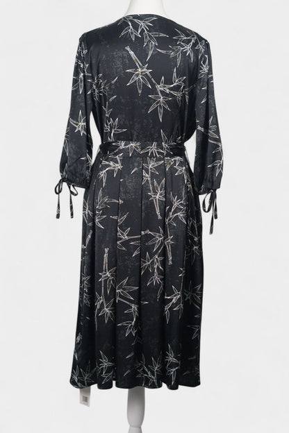 Women's black Gambiered Guangdong Gauze wrap dress with white bamboo leaf print and tie-cuff sleeves.