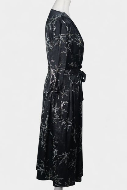 Women's black Gambiered Guangdong Gauze wrap dress with white bamboo leaf print and tie-cuff sleeves.