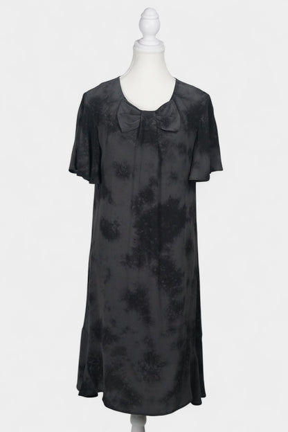 Women's black and grey patterned silk dress with a bow neckline and short flutter sleeves on a mannequin.