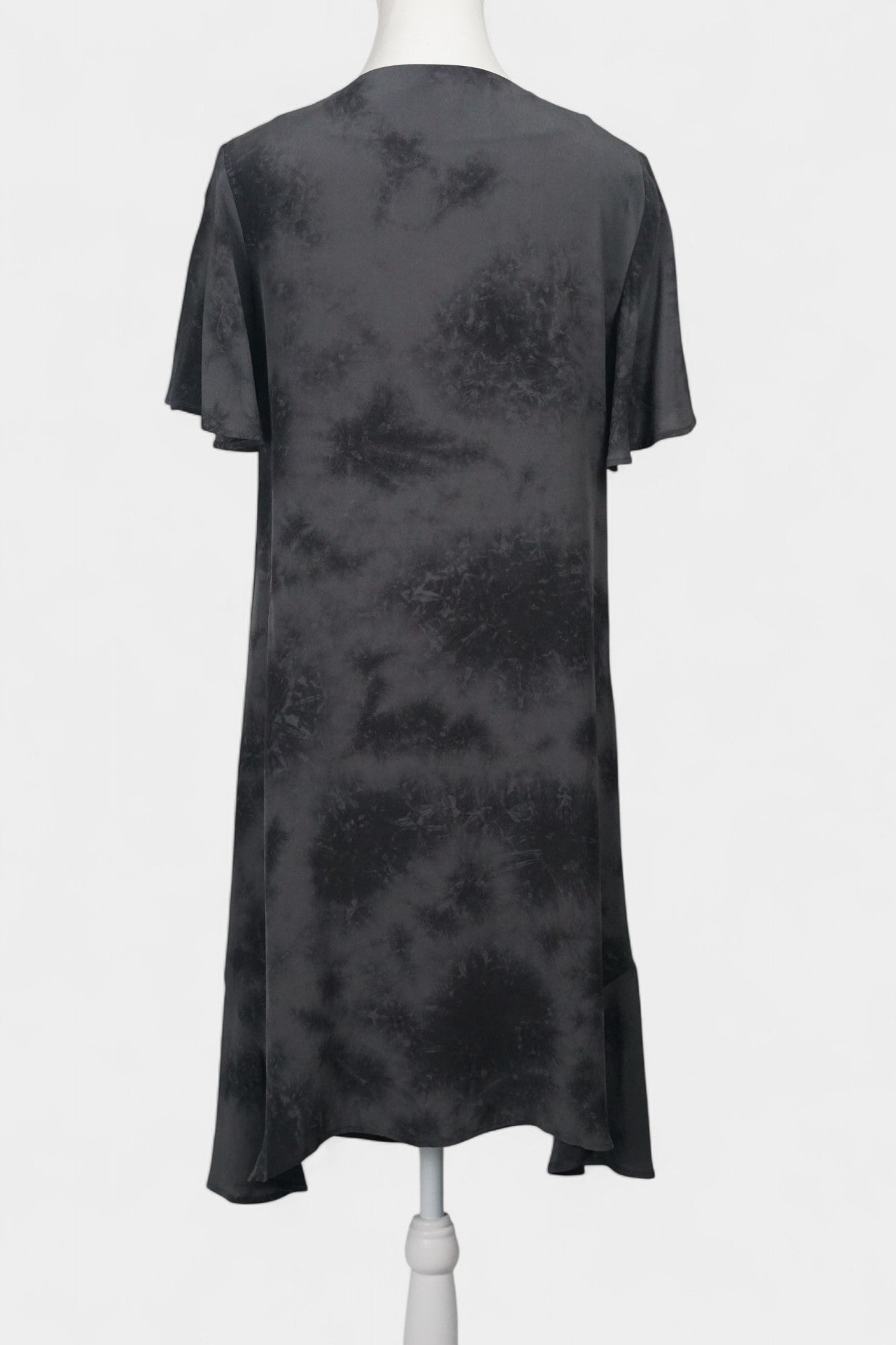 Women's black and grey patterned silk dress with a bow neckline and short flutter sleeves on a mannequin.