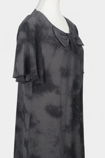 Women's black and grey patterned silk dress with a bow neckline and short flutter sleeves on a mannequin