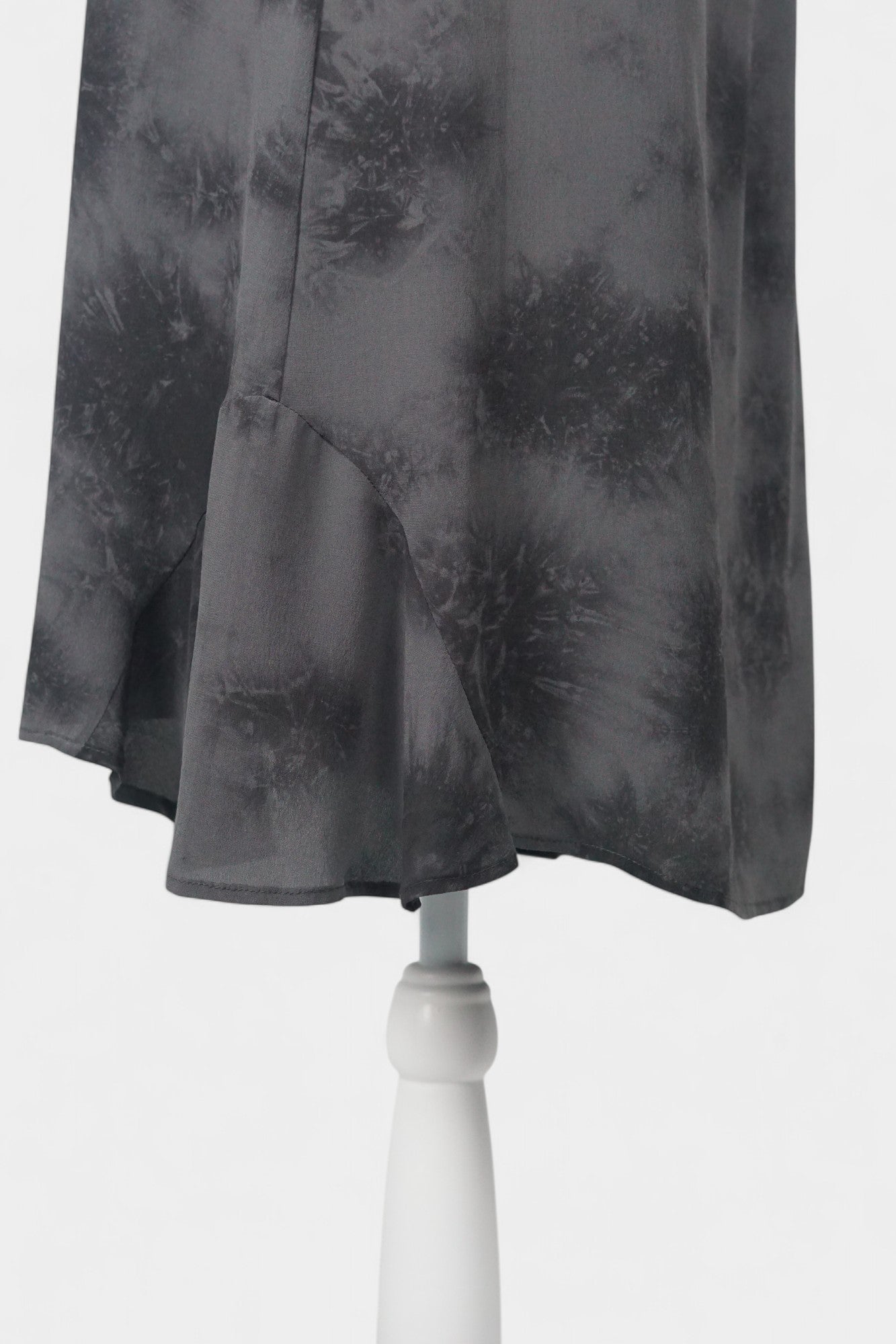 Women's black and grey patterned silk dress with a bow neckline and short flutter sleeves on a mannequin.