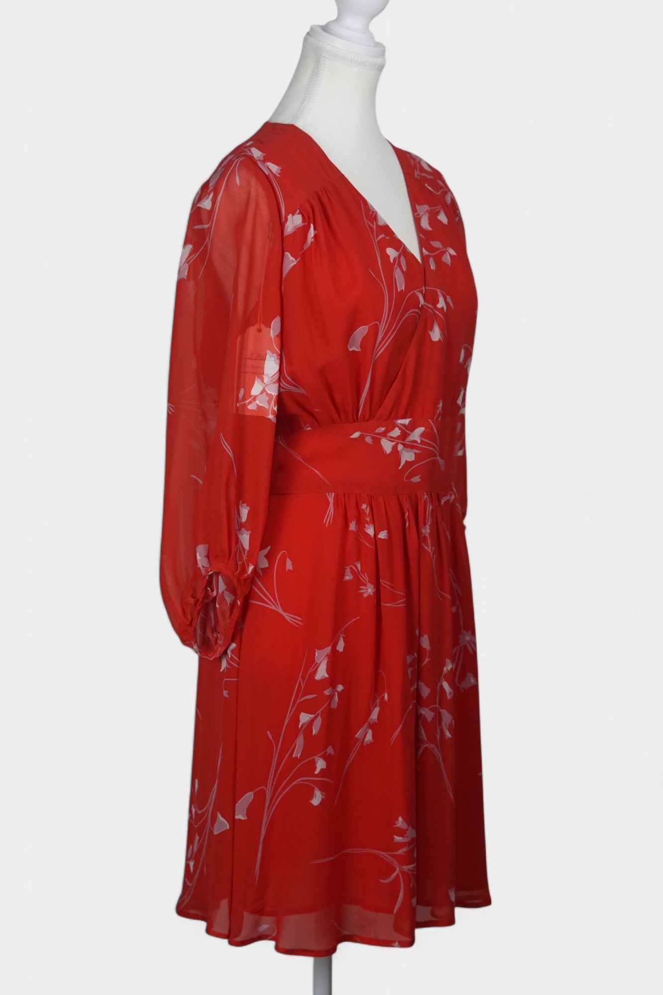 Women's red silk dress with white floral print, featuring a V-neck, wide waistband, and long sheer sleeves