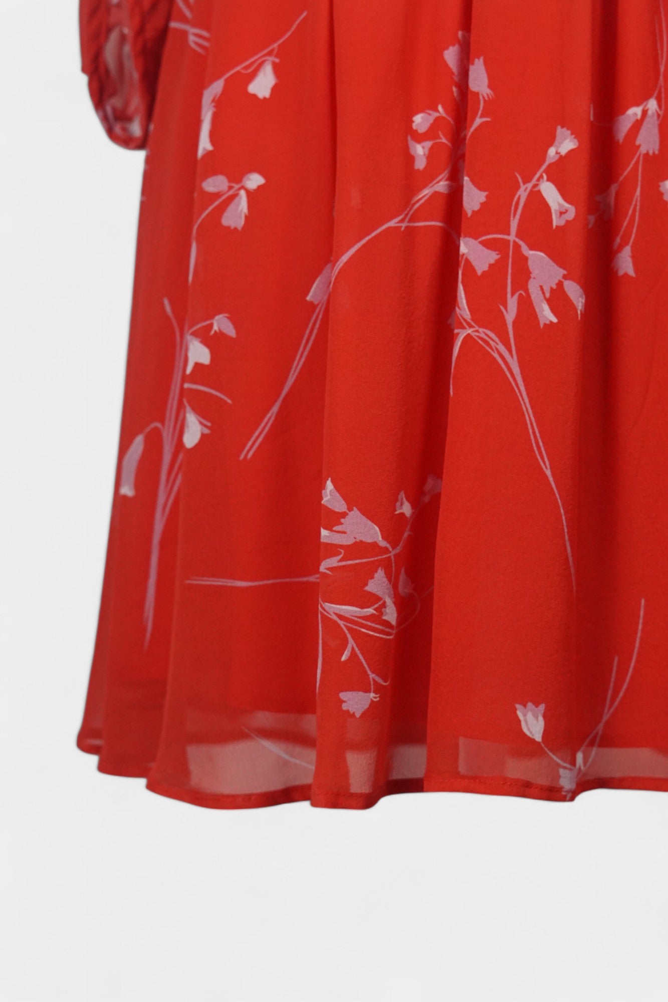 Women's red silk dress with white floral print, featuring a V-neck, wide waistband, and long sheer sleeves