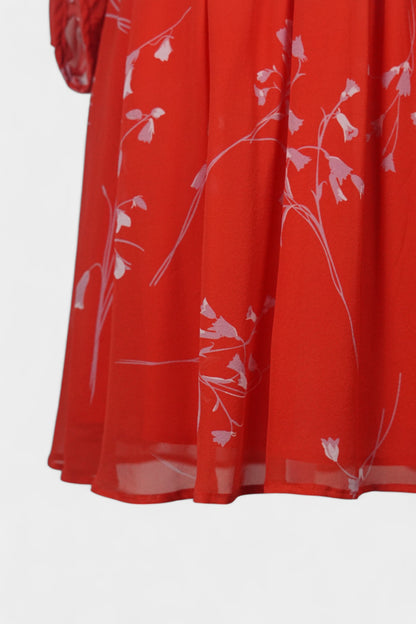 Women's red silk dress with white floral print, featuring a V-neck, wide waistband, and long sheer sleeves