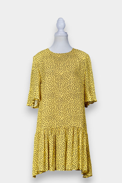 Women's yellow silk dress with black polka dots, featuring elbow-length ruffled sleeves and a gathered drop-waist hem.