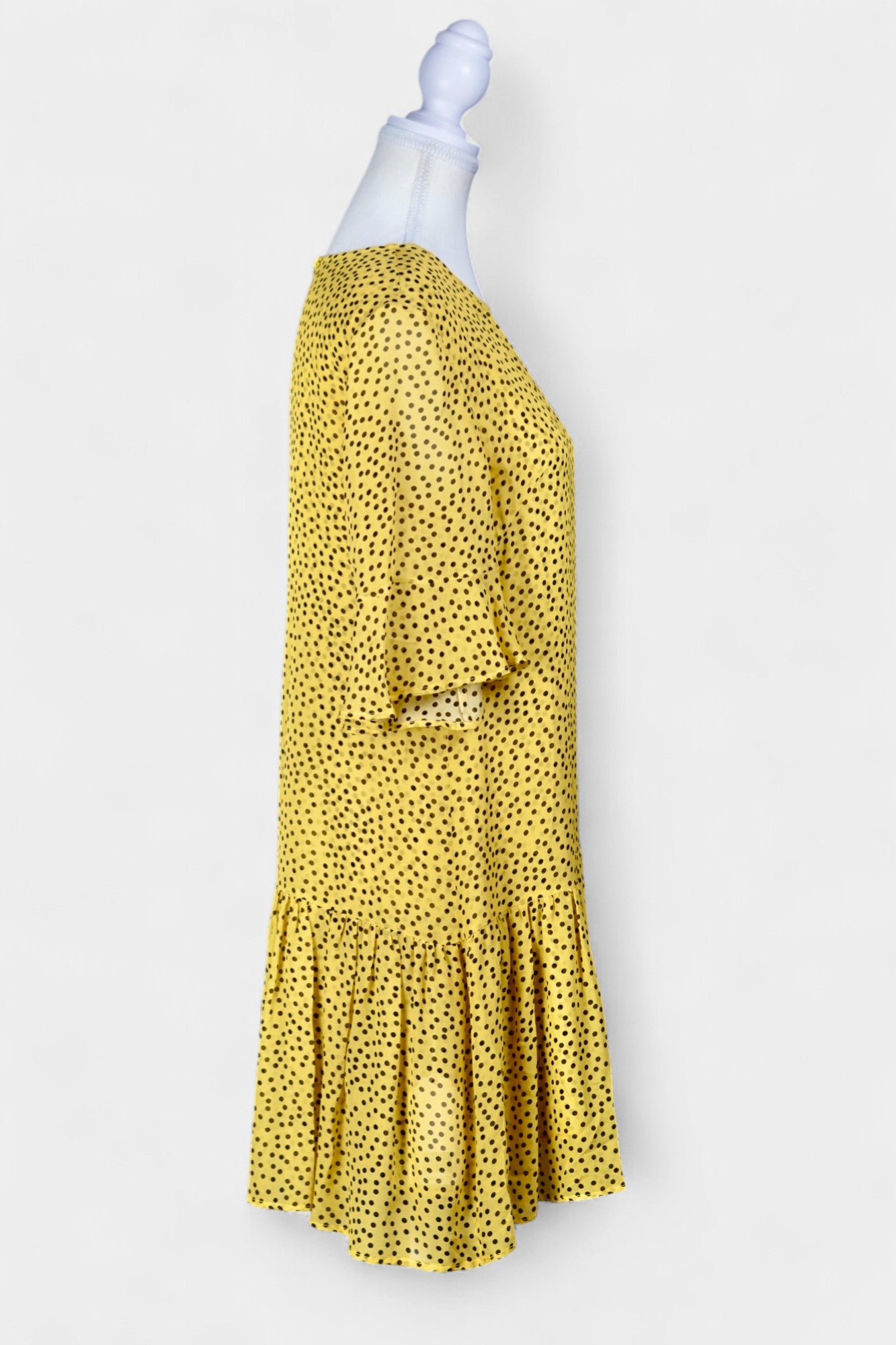 Women's yellow silk dress with black polka dots, featuring elbow-length ruffled sleeves and a gathered drop-waist hem.