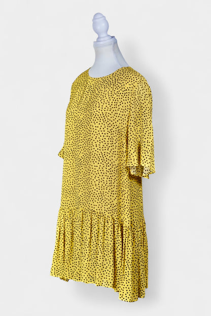 Women's yellow silk dress with black polka dots, featuring elbow-length ruffled sleeves and a gathered drop-waist hem.