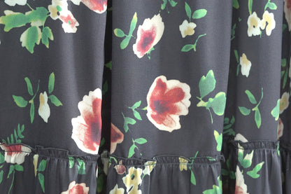 Black floral silk midi skirt with elastic waistband and tiered ruffle hem