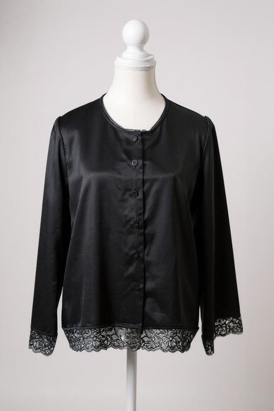 Black silk jacket featuring delicate lace trim on cuffs and hem, with button-down front