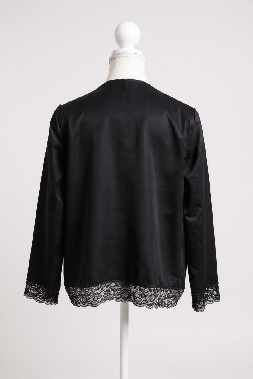 Black silk jacket featuring delicate lace trim on cuffs and hem, with button-down front