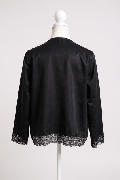 Black silk jacket featuring delicate lace trim on cuffs and hem, with button-down front