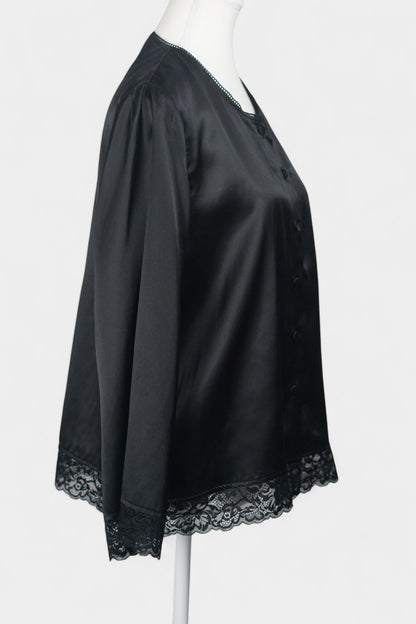 Black silk jacket featuring delicate lace trim on cuffs and hem, with button-down front