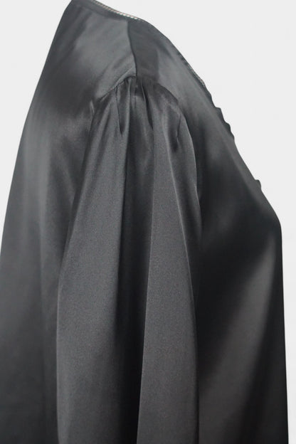 Black silk jacket featuring delicate lace trim on cuffs and hem, with button-down front