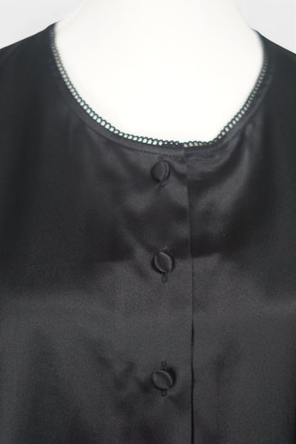 Black silk jacket featuring delicate lace trim on cuffs and hem, with button-down front