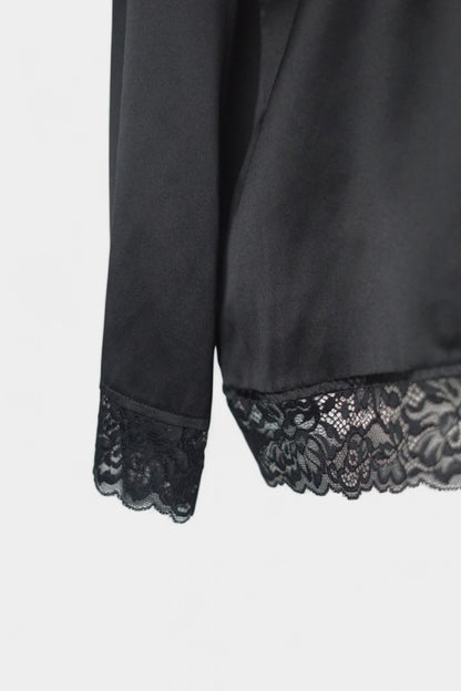 Black silk jacket featuring delicate lace trim on cuffs and hem, with button-down front