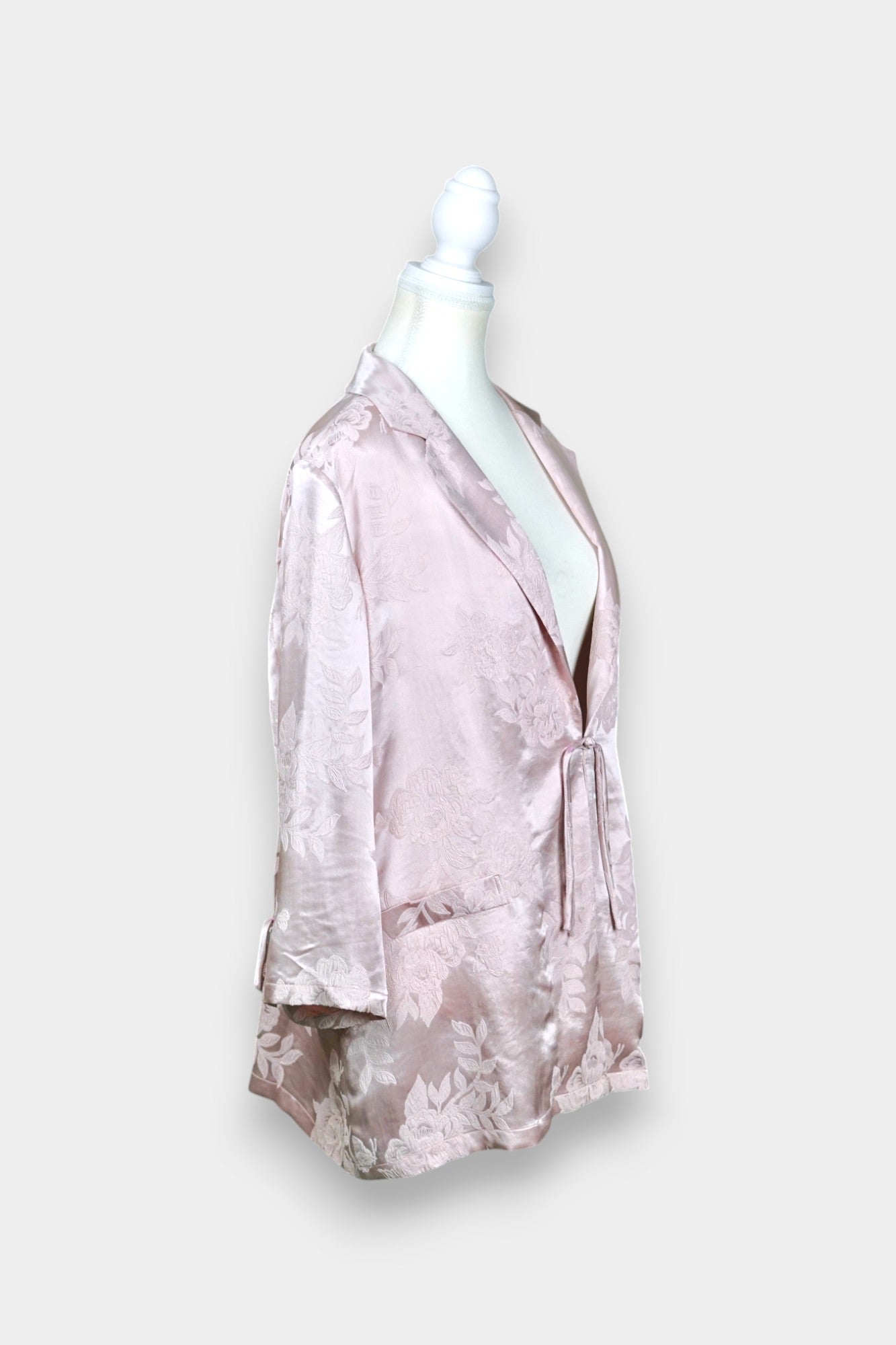 Dusty pink silk jacquard blazer featuring floral pattern and ribbon tie-front closure