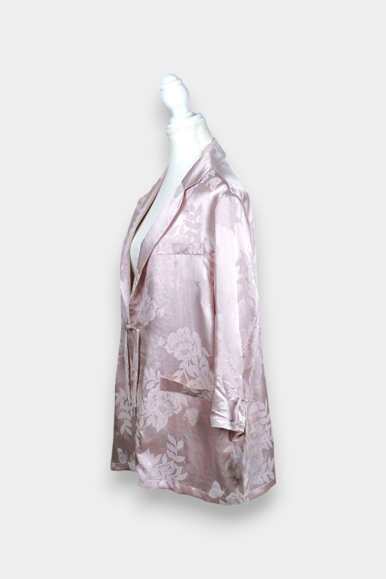 Dusty pink silk jacquard blazer featuring floral pattern and ribbon tie-front closure