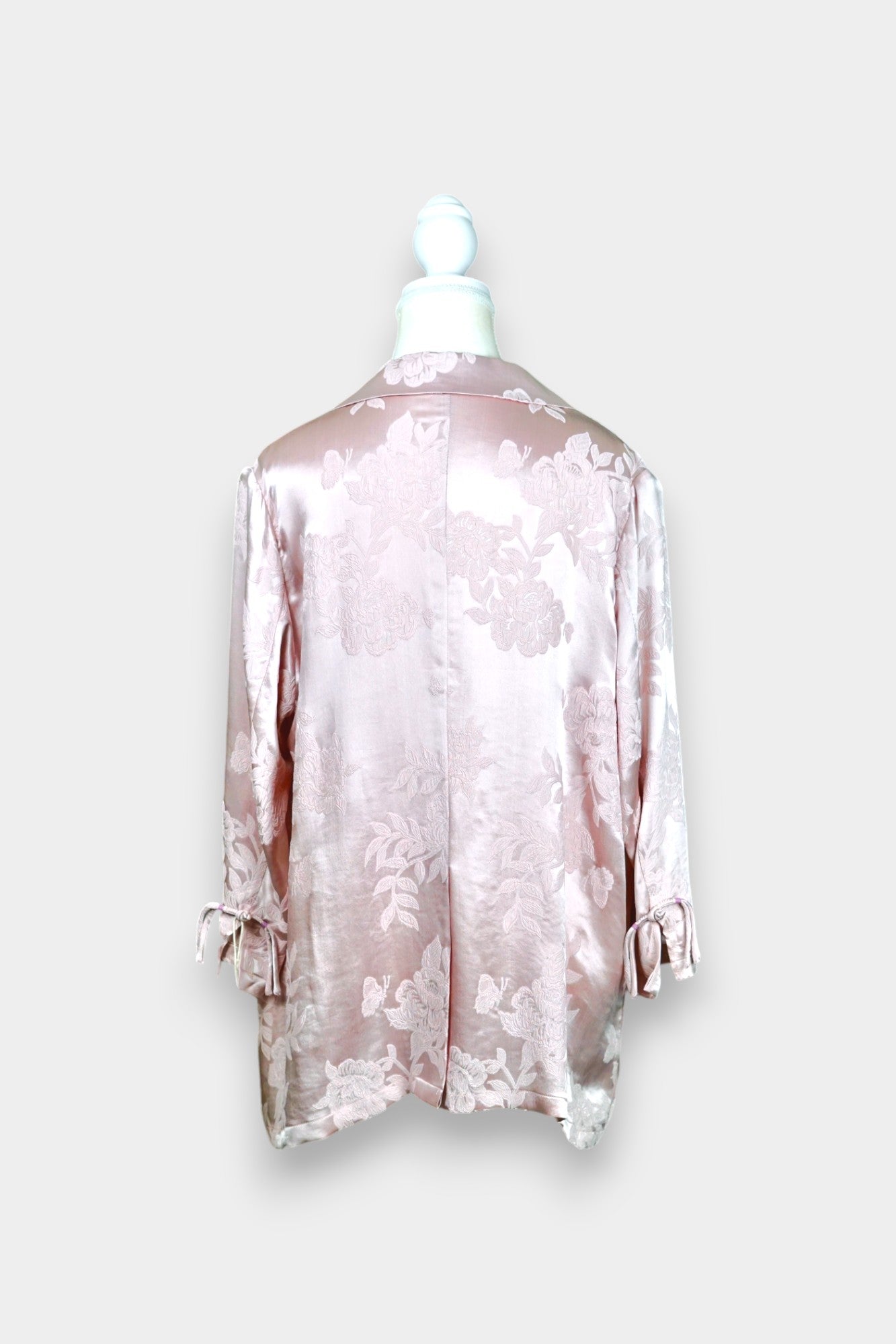 Dusty pink silk jacquard blazer featuring floral pattern and ribbon tie-front closure