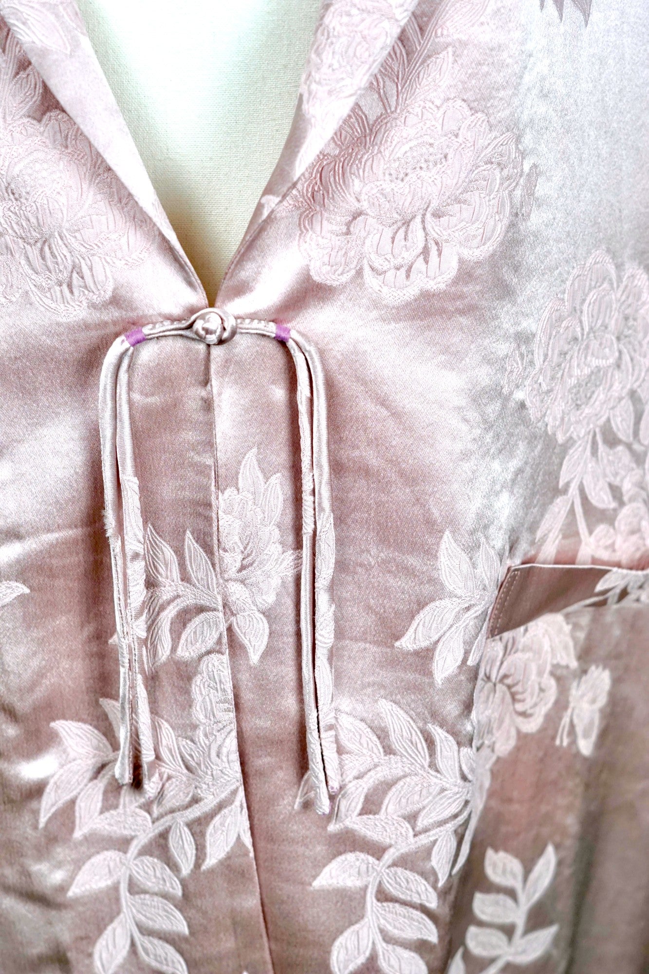 Dusty pink silk jacquard blazer featuring floral pattern and ribbon tie-front closure