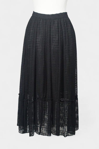 Semi-sheer noir skirt with intricate geometric cutouts, featuring a comfortable elastic waistband and a tiered flounce hem.