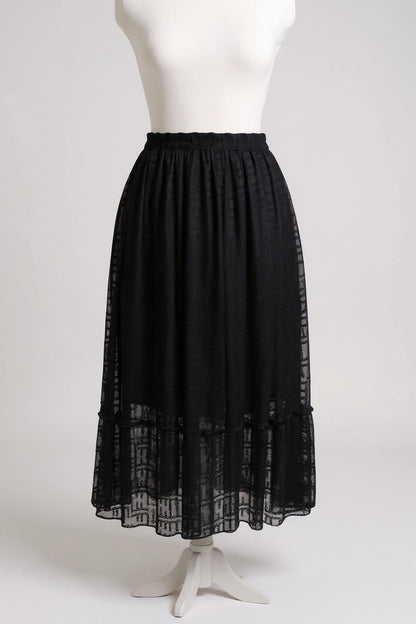 Semi-sheer noir skirt with intricate geometric cutouts, featuring a comfortable elastic waistband and a tiered flounce hem.