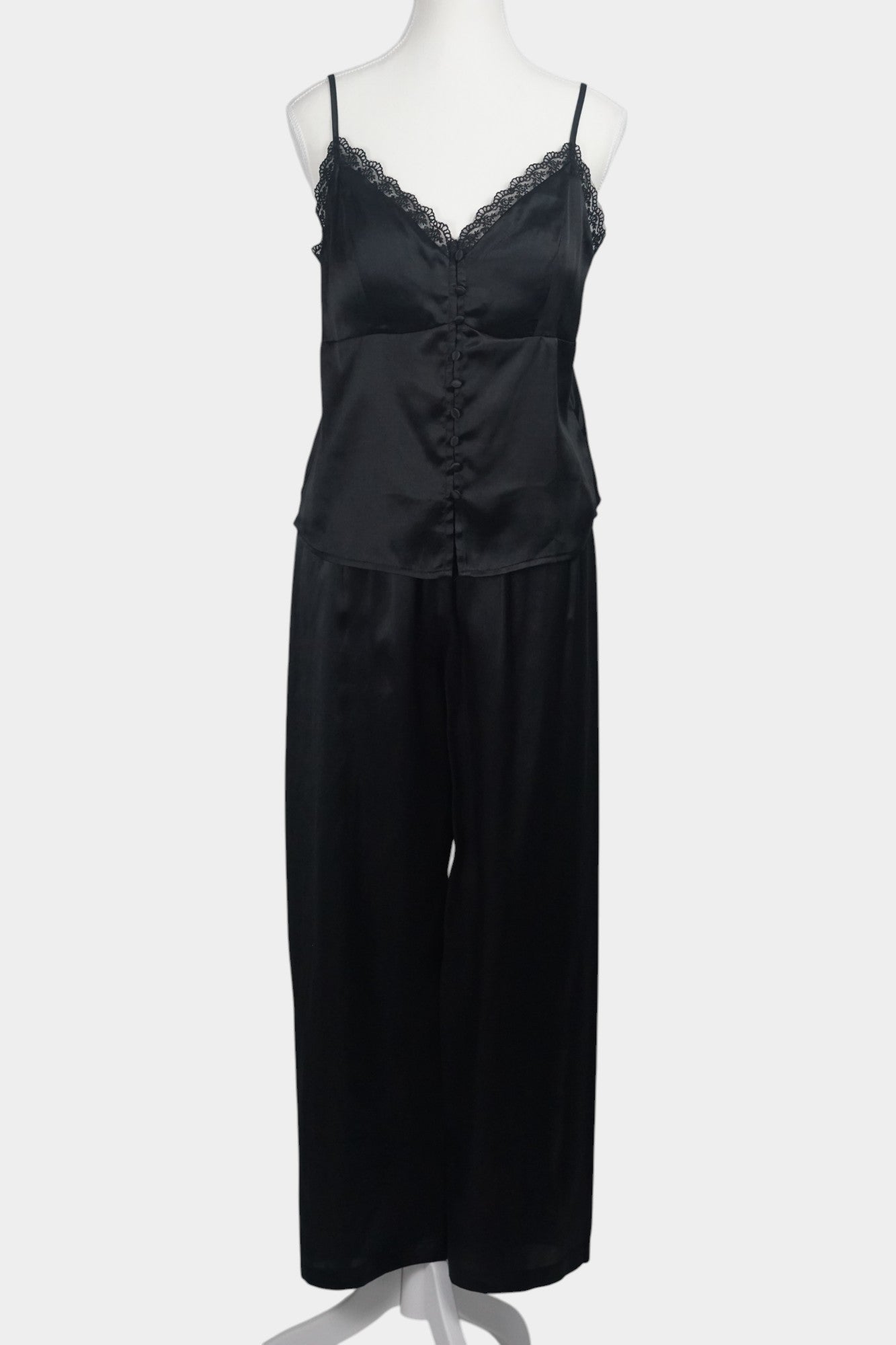 Black silk two-piece set featuring a lace-trimmed camisole top with button details and matching wide-leg trousers.