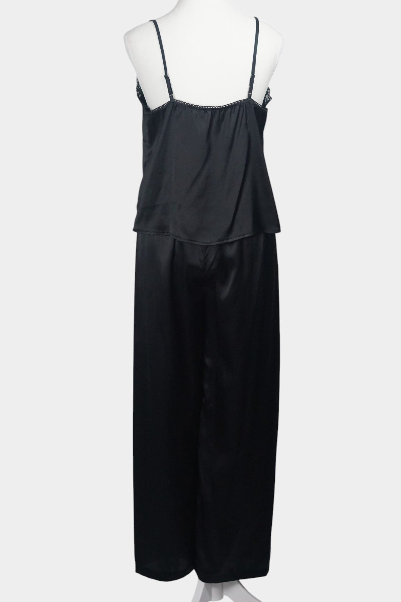 Black silk two-piece set featuring a lace-trimmed camisole top with button details and matching wide-leg trousers.