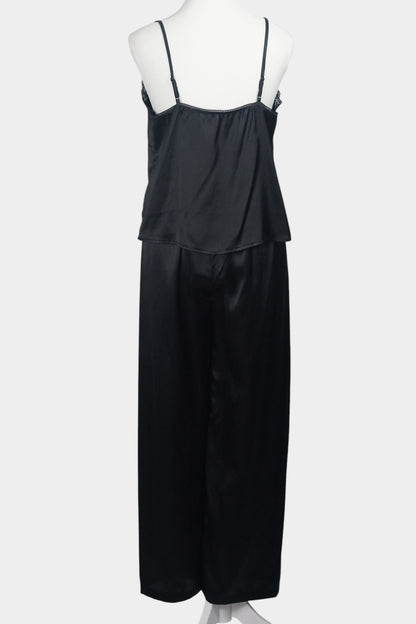 Black silk two-piece set featuring a lace-trimmed camisole top with button details and matching wide-leg trousers.