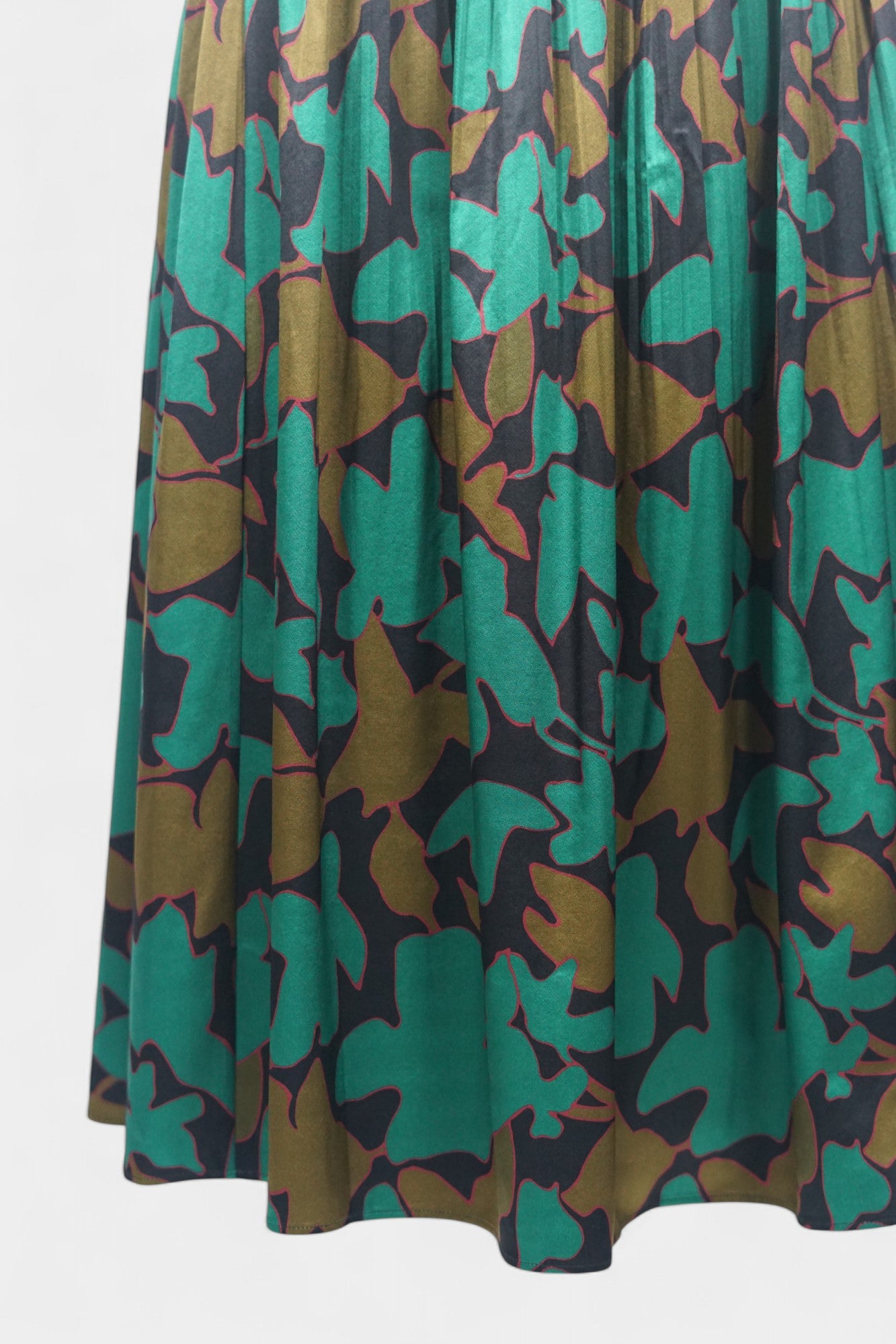 Flowy A-line skirt with smocked waist in lustrous green and copper abstract design