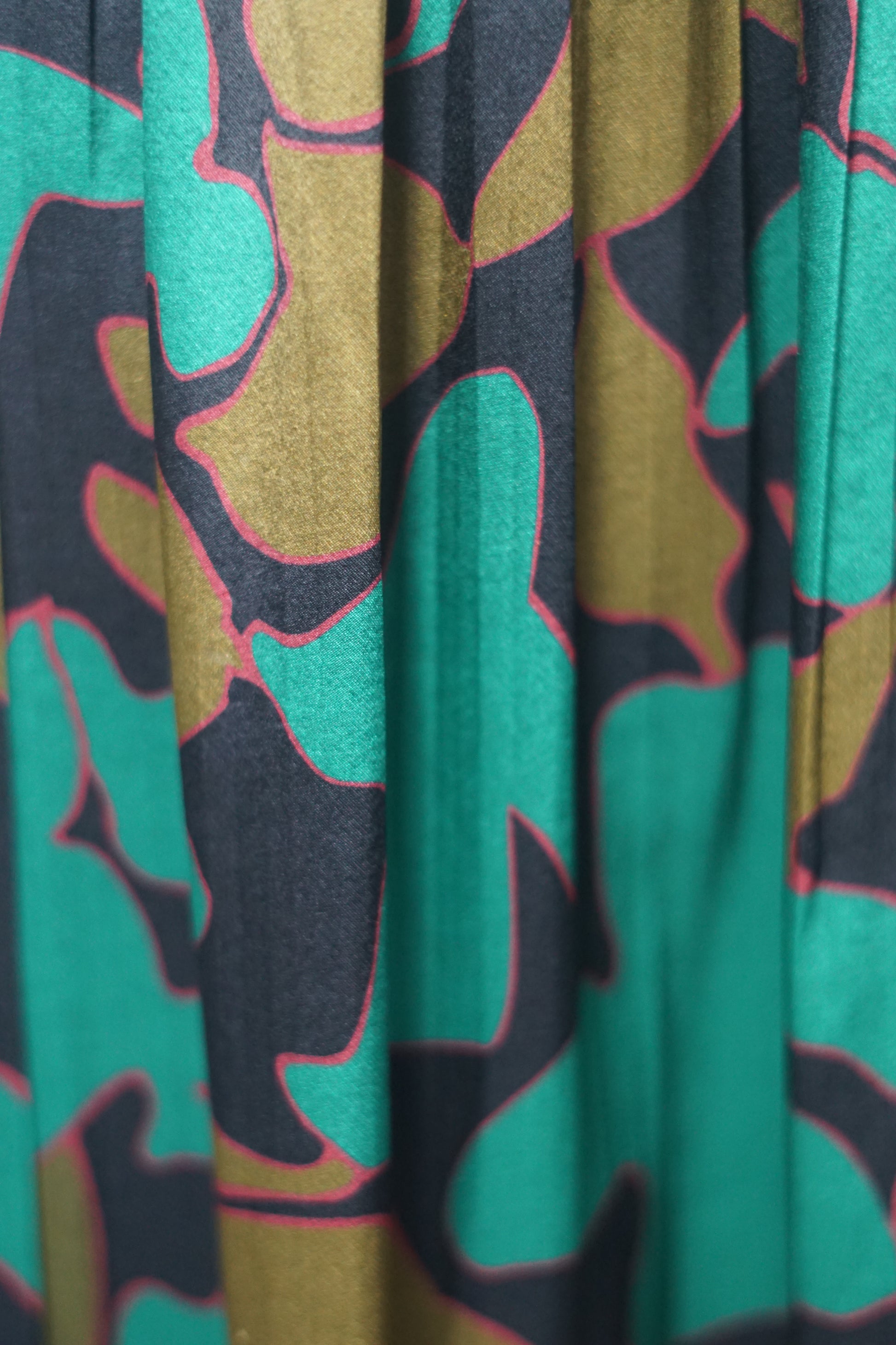 Flowy A-line skirt with smocked waist in lustrous green and copper abstract design