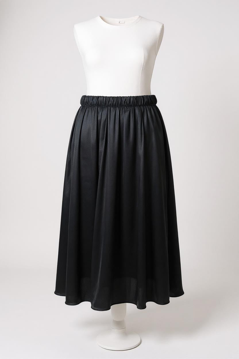 Solid black silk midi skirt featuring a comfortable elastic waistband and gathered A-line silhouette