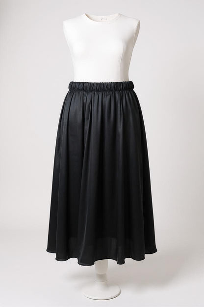 Solid black silk midi skirt featuring a comfortable elastic waistband and gathered A-line silhouette