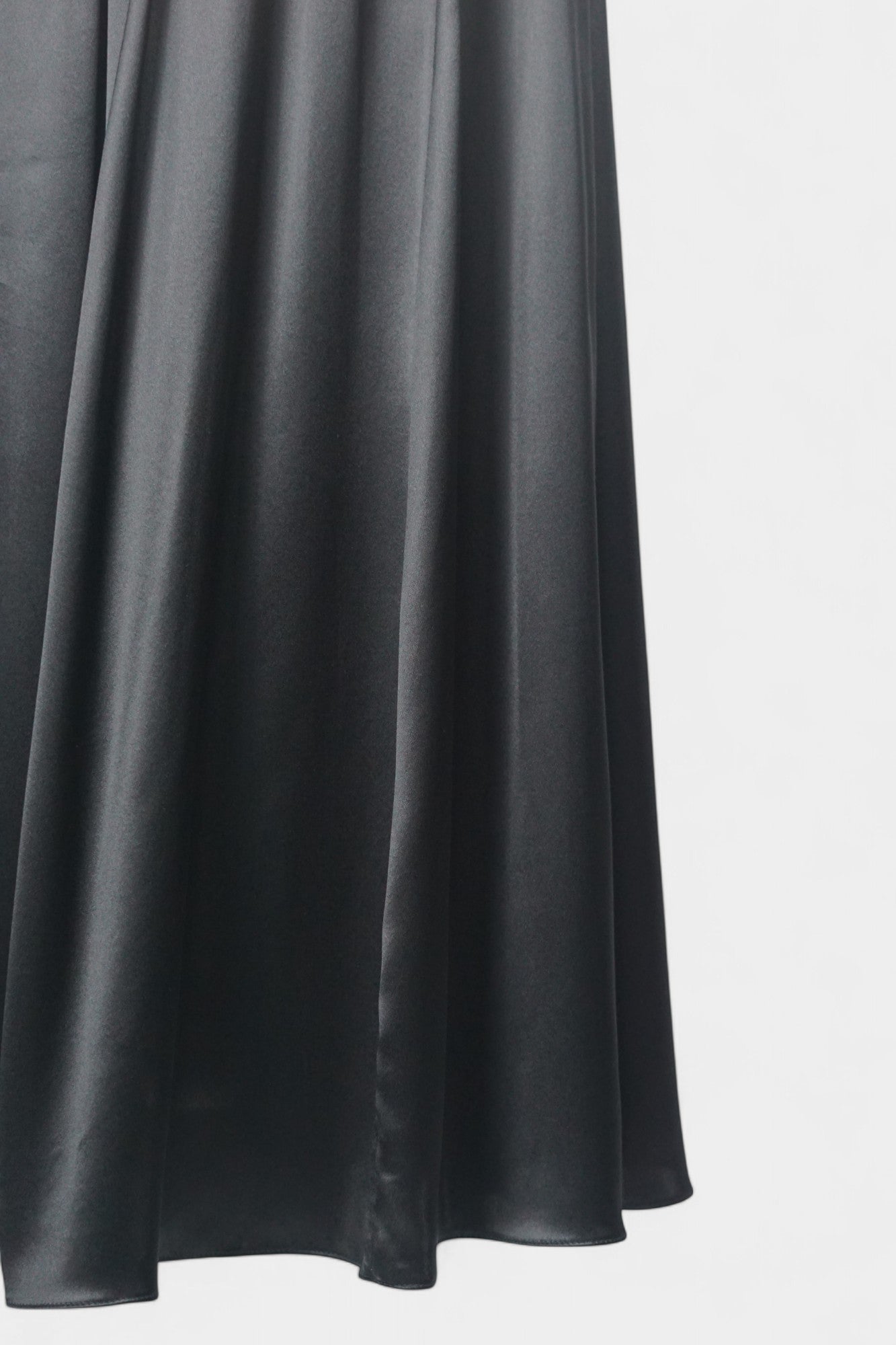 Solid black silk midi skirt featuring a comfortable elastic waistband and gathered A-line silhouette
